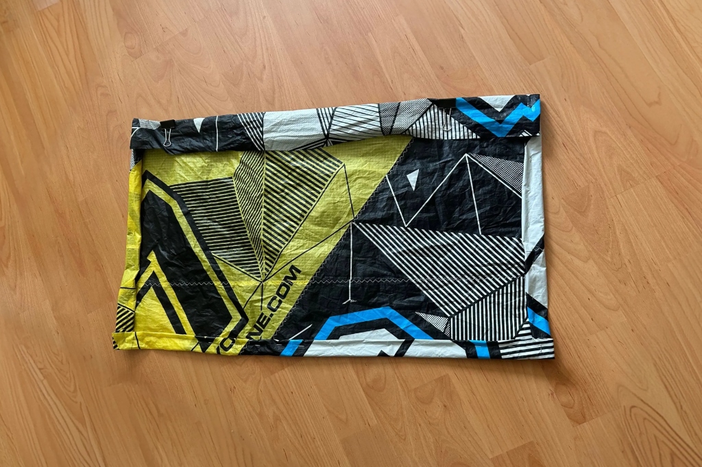 Handmade raw-cut upcycled tote bag folded and secured using steel staples.